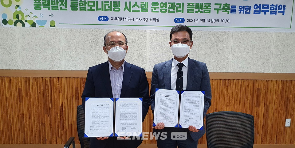 ▲황우현 제주에너지공사 사장(왼쪽)과 김정우 에이투엠 대표가 협약식을 마치고 협약서를 보여주고 있다.