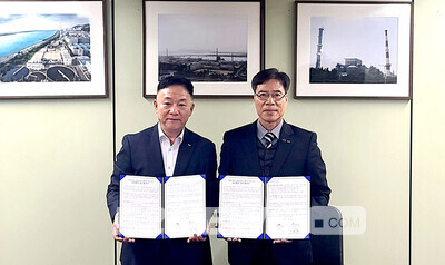 류재영 SK에코엔지니어링 Gas&Power사업 담당임원과 김병수 부산패션칼라산업협동조합 이사장이 협약서를 보이며 협력을 다짐하고 있다.